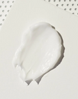Close up image of smear of skincare product. REPLENIX Age Restore Nighttime Therapy.